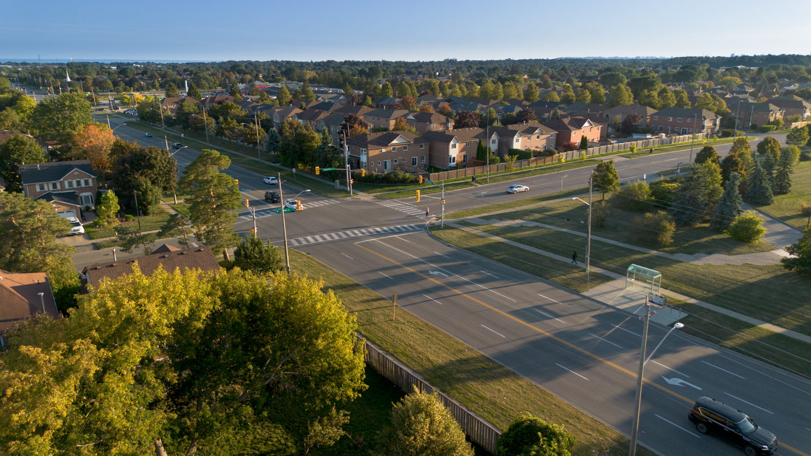 Aerial view of a suburban street corner at sunset. Drone Photography
